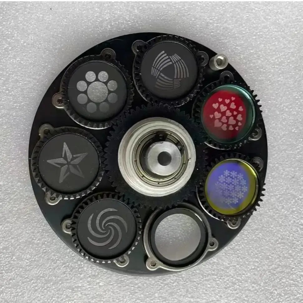 Glass gobo wheel with colour and monochrome patterns mounted in toothed carriers