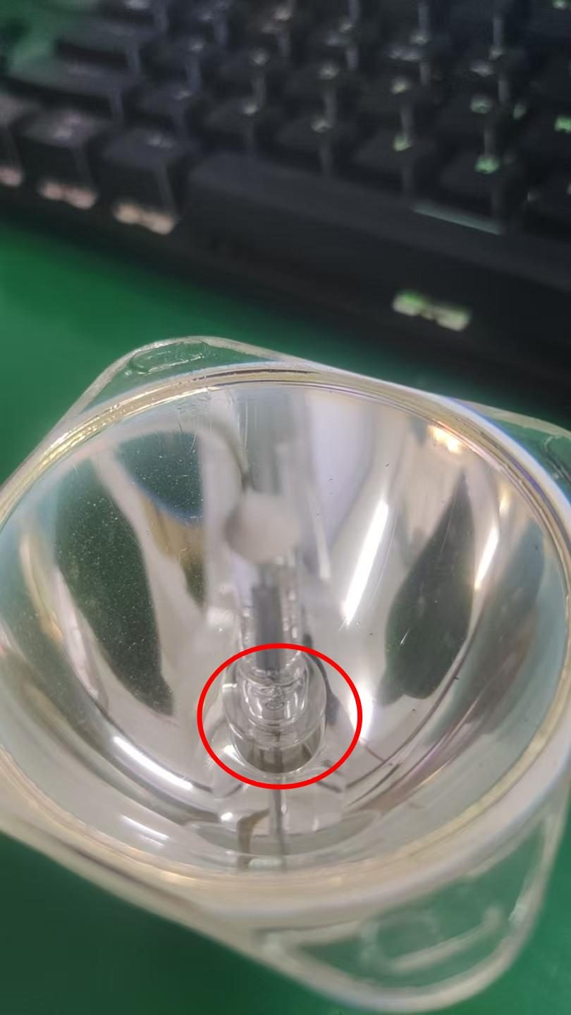 Close-up of a discharge lamp showing a whitened or blackened bulb core